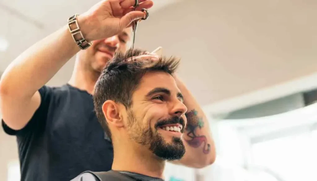 Man getting his hair cut at a barber shop, showcasing a Men Hairstyles Quiff.