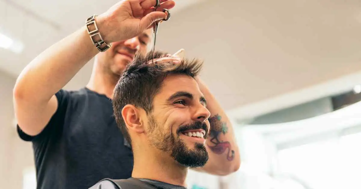 Man getting his hair cut at a barber shop, showcasing a Men Hairstyles Quiff.