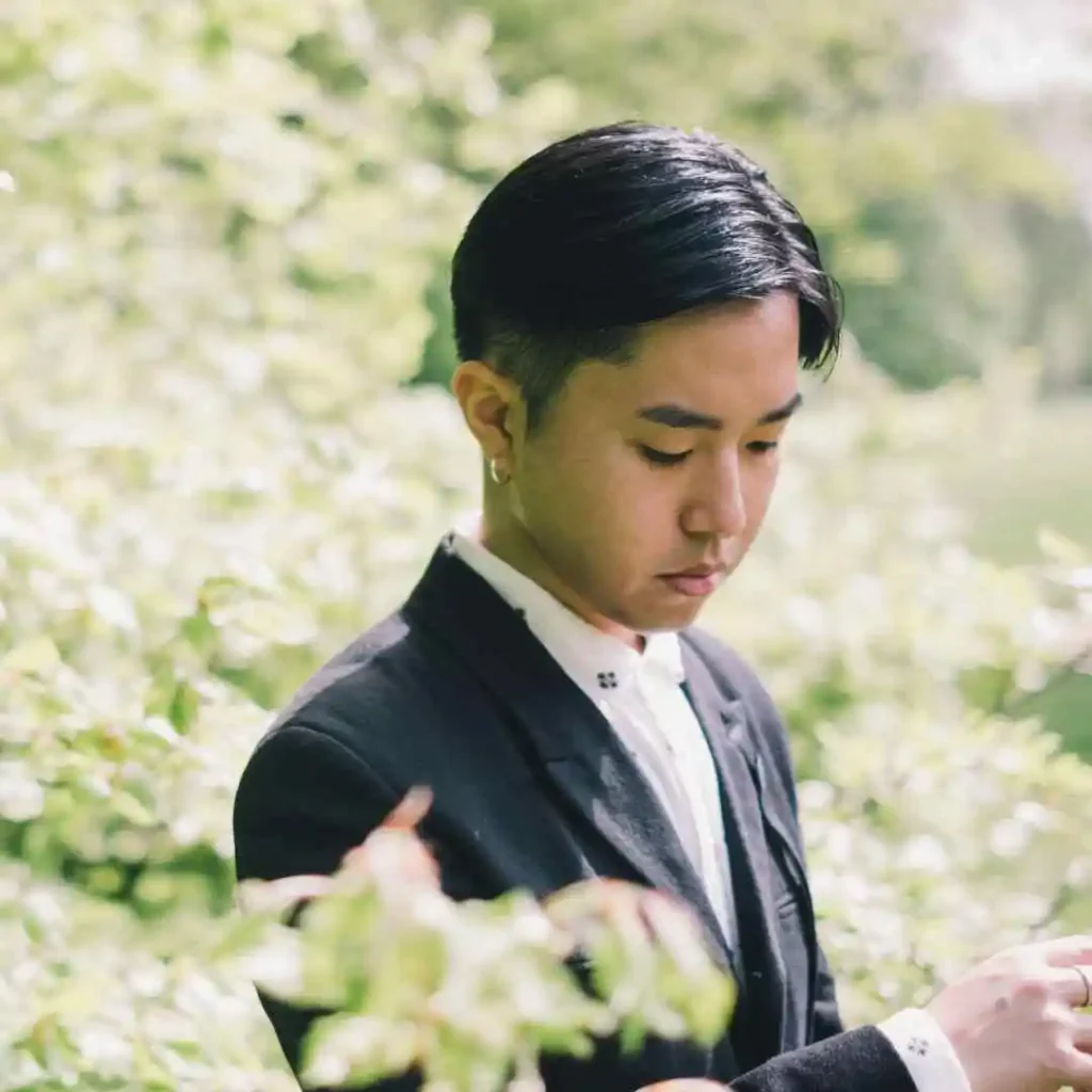 a man in a suit is looking at his cell phone