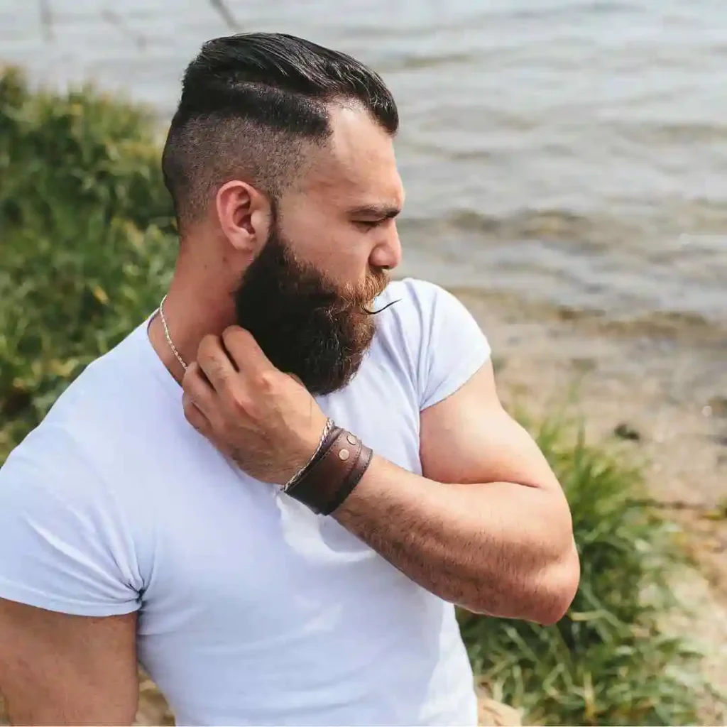 a man with a goatee combing his hair