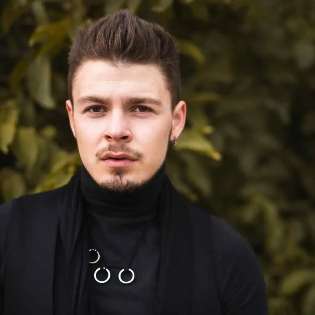 a man wearing a black shirt and a black scarf