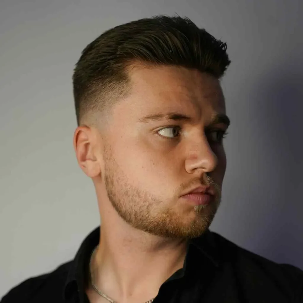 a man with a black shirt and a necklace