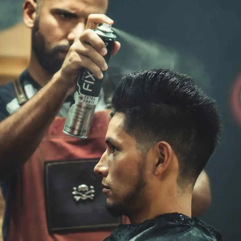 a man getting his hair cut by a barber