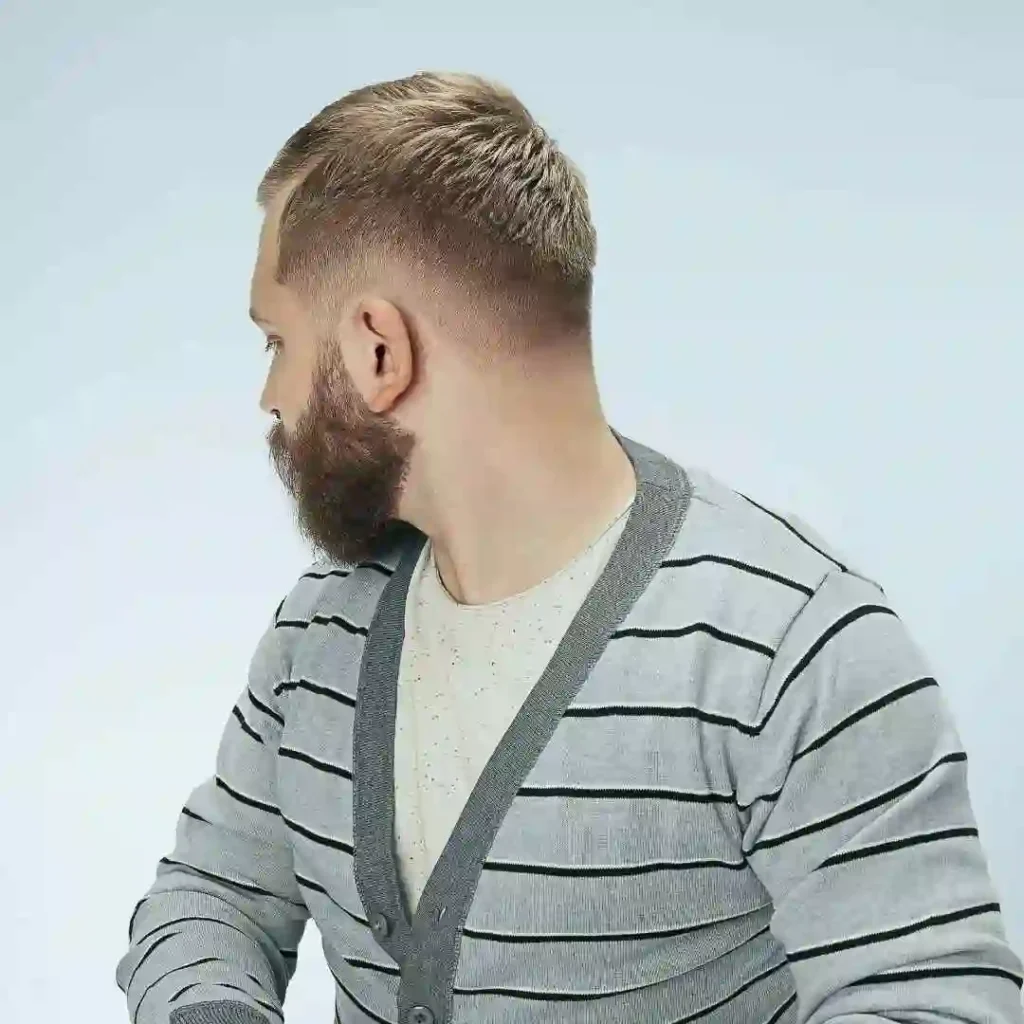 a man with a beard wearing a sweater