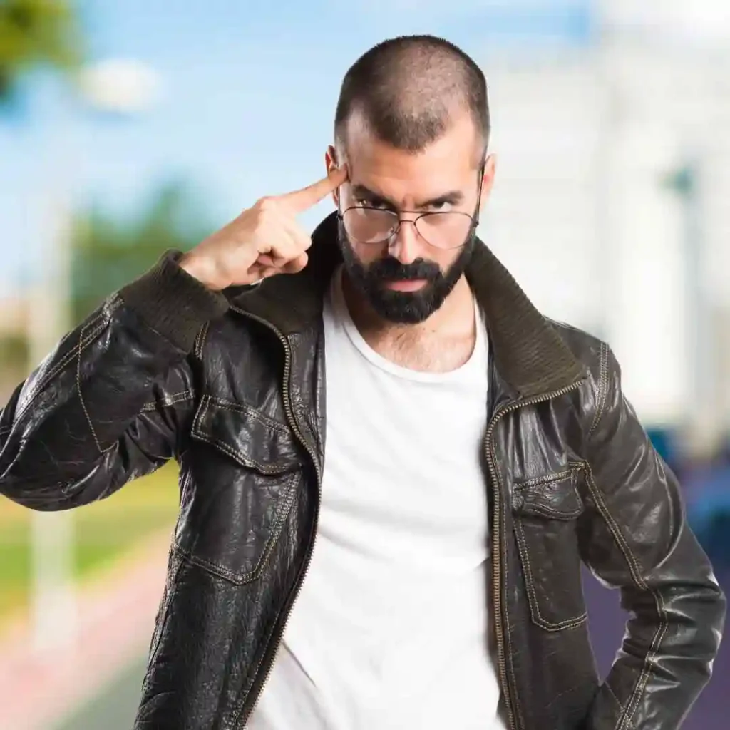 a man wearing glasses and a leather jacket