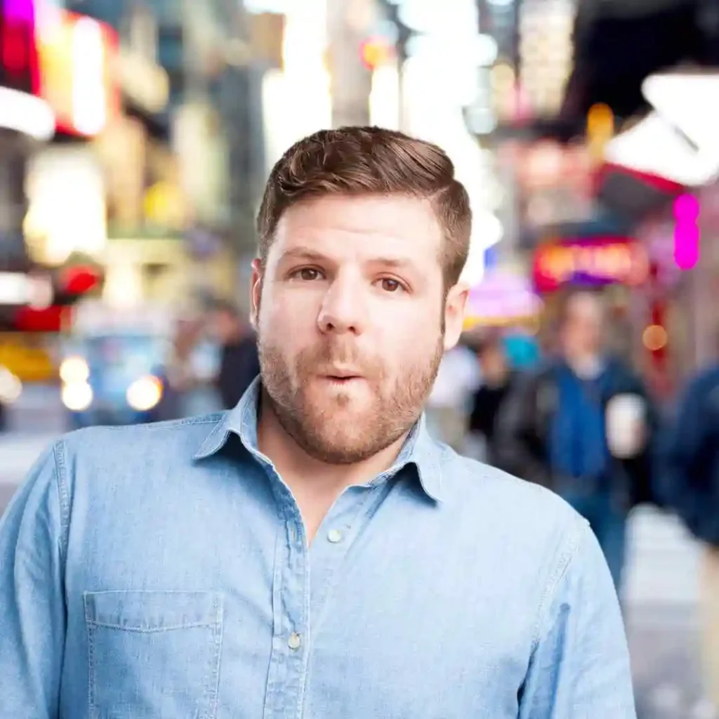 a man making a face while standing on a city street