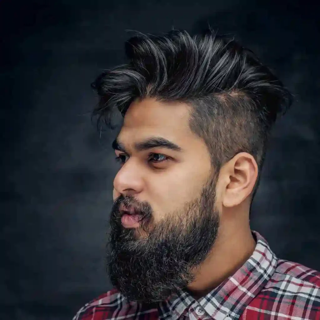 A man with a beard wearing a checkered shirt, showcasing a rugged, stylish look. All beard styles and men's fashion.