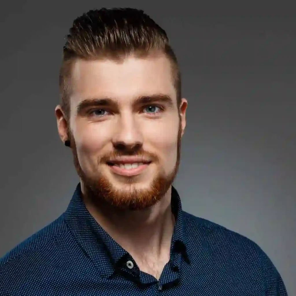 a man with a beard wearing a blue shirt