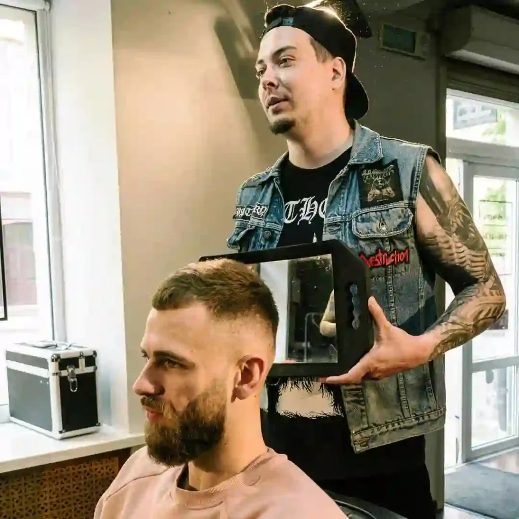 A man is getting his hair cut by a barber, showcasing haircuts for men with diamond face.