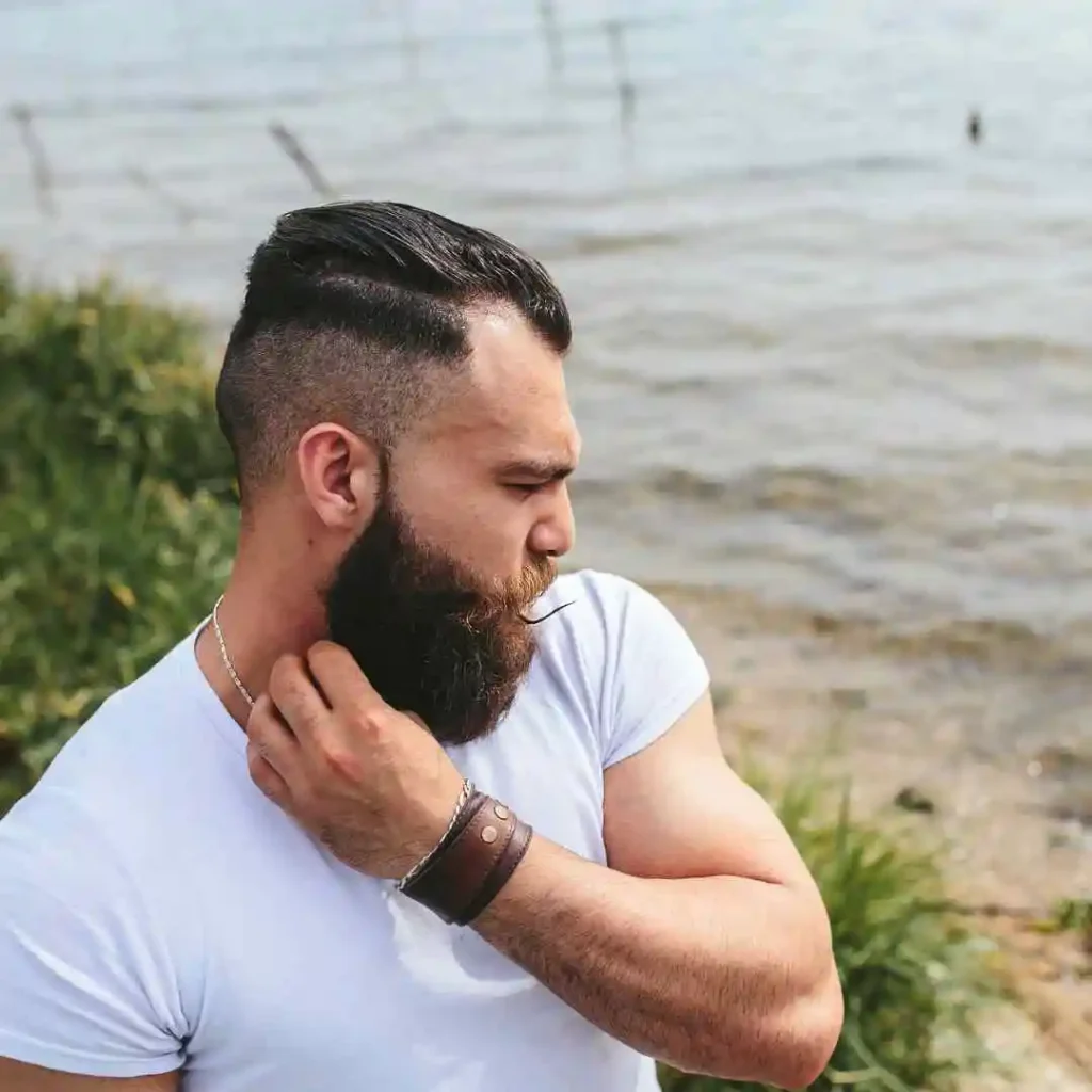 A man is getting his hair cut by a barber, showcasing haircuts for men with diamond face.