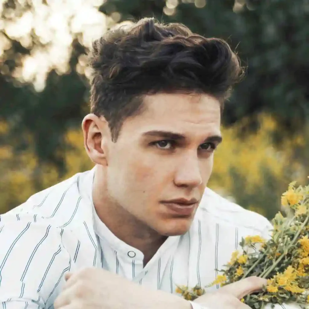 A man holding a bunch of flowers in his hands, showcasing haircuts for men with diamond face.