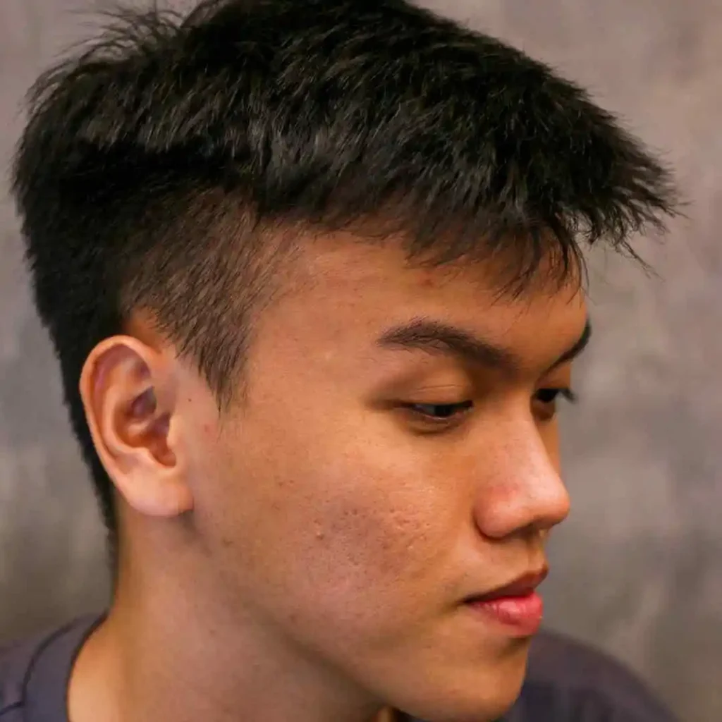 a close up of a person with a short haircut