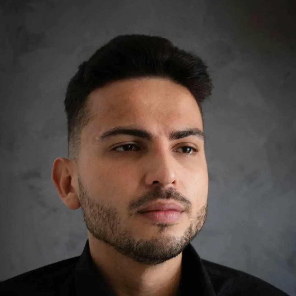 A close-up of a person wearing a black shirt, showcasing haircuts for men with diamond face.