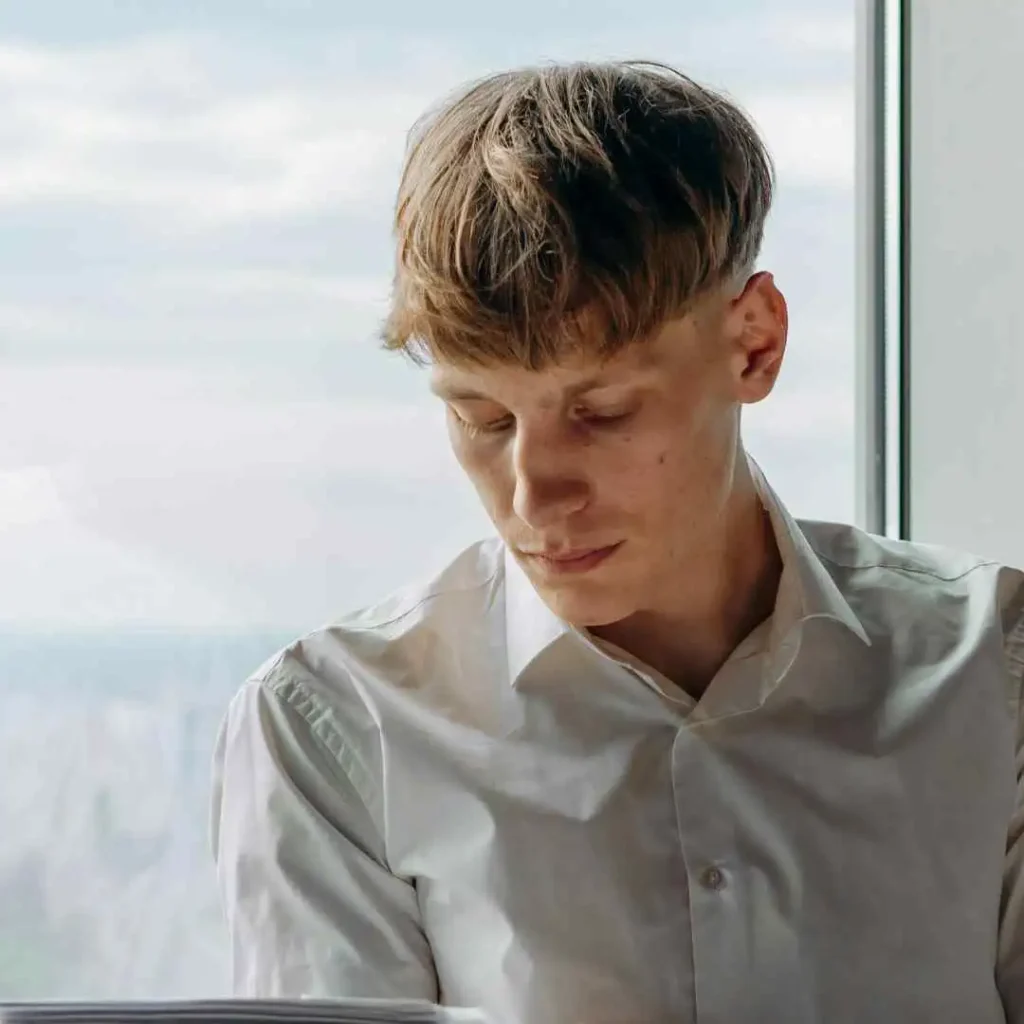 a young man reading a book