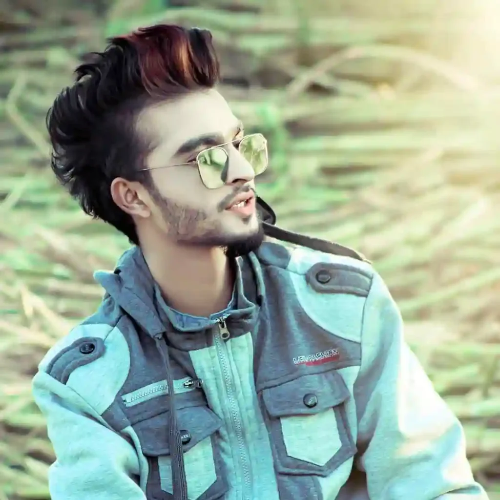 A young person in a stylish gray jacket with unique pockets, surrounded by nature and warm sunlight.