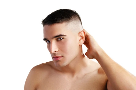 Men Hairstyles Indian- Trendy Looks For Your Unique Personality 6 A shirtless individual showcasing men hairstyles Indian style, with short hair, touching the back of their neck against a white background.