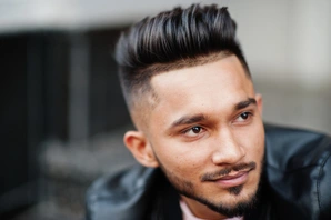 Men Hairstyles Indian- Trendy Looks For Your Unique Personality 7 A close-up of a stylish individual wearing a black leather jacket, showcasing a fashionable, well-groomed look that highlights popular men hairstyles Indian trends.