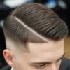 A stylish example of side parted mens hairstyles, featuring a neatly combed look with a sharp side part and a faded undercut, showcasing smooth, textured locks.