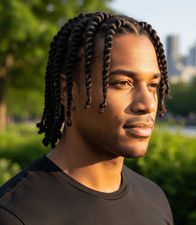 27 Best Protective Hairstyles for Men- On-trend and Comfortable 7 A man in a black shirt representing a stylish protective hairstyle for men