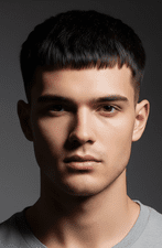 A man in a grey shirt sporting a Caesar cut, representing a fashionable option for men with thin hair